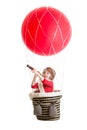 Kid on hot air balloon watching through spyglass