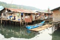 Kid by house above sea in Manokwari Royalty Free Stock Photo