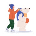 Kid ice skating with skating helper bear. Child skates training aid. Winter season sport activity for kids. Young girl in outdoor Royalty Free Stock Photo