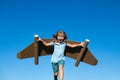 Kid with jet pack superhero. Child pilot against summer sky background. Boy with paper plane flight, toy airplane with Royalty Free Stock Photo