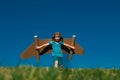 Kid with jet pack superhero. Child pilot against summer sky background. Boy with paper plane flight, toy airplane with Royalty Free Stock Photo