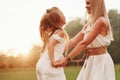 Kid is jumping. Mother and daughter enjoying weekend together by walking outdoors in the field. Beautiful nature Royalty Free Stock Photo