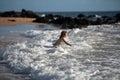 Kid Jumping in Sea Ocean Waves. Jump by Water splashes. Summer day, ocean coast, Beach. Active kids lifestyle and Royalty Free Stock Photo