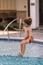 Kid jumping in swim pool. Child splashing in summer water pool. Kid splash in pool. Excited happy kid boy jumping in Royalty Free Stock Photo