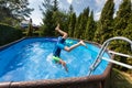 Kid jumping in swimming pool during staycation Royalty Free Stock Photo