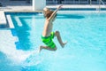 Kid jumping in water pool. Kid enjoying summer holiday, swiming in pool. Kid having fun on summer holidays at pool Royalty Free Stock Photo