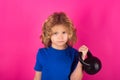 Kid with kettlebell in studio on red pink background. Child workout. Kid sport. Child exercising with kettlebell. Sporty Royalty Free Stock Photo