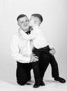 Kid kiss his father. tuxedo style. little boy with dad businessman. family day. esthete. male fashion. happy child with