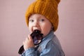 Kid in knitted mustard color hat