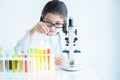 Kid in lab coat learning chemistry in school laboratory, Kid scientist studying science, experimenting with chemicals, Young