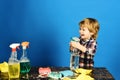 Kid with laughing face spraying water out of spray bottle. Royalty Free Stock Photo