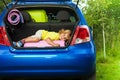 Kid laying on the bags waiting for vacation Royalty Free Stock Photo