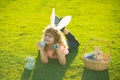 Kid laying on grass in park wit easter eggs. Happy easter bunny child boy. Spring kids holidays concept.