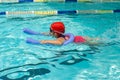 Kid learn how to swim in swimming class