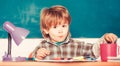 Kid is learning in class on background of blackboard. Back to school. Preschooler. Preschooler near the blackboard Royalty Free Stock Photo