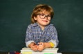 Kid is learning in class on background of blackboard. Little children at school lesson. Home schooling Royalty Free Stock Photo