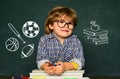 Kid is learning in class on background of blackboard. Little children at school lesson. Home schooling Royalty Free Stock Photo