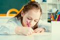 Kid is learning in class on background of blackboard. Preschool education. Home school for pupil. Royalty Free Stock Photo