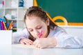 Kid is learning in class on background of blackboard. Preschool education. Home school for pupil. Royalty Free Stock Photo