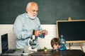 Kid is learning in class on background of blackboard. School. Good teachers enjoy teaching. Little kids scientist Royalty Free Stock Photo