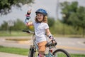 Kid learning to ride bike. Child riding bicycle. Little kid boy in helmet on bicycle along bikeway. Happy cute little Royalty Free Stock Photo