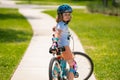 Kid learning to ride bike. Child riding bicycle. Little kid boy in helmet on bicycle along bikeway. Happy cute little Royalty Free Stock Photo