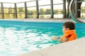 Happy little kid boy having fun in an swimming pool. Active happy preschool child learning to swim. Royalty Free Stock Photo