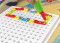 Kid learning to use screwdriver. Multicolor screws. Future occupation concept Royalty Free Stock Photo