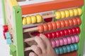 Kid learns on mathematic concept using colorful counting beads. Royalty Free Stock Photo