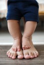 The kid learns to take first steps with the help of his mother, close-up Royalty Free Stock Photo