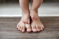 The kid learns to take first steps with the help of his mother, close-up Royalty Free Stock Photo