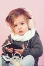 Kid listen music with headset and mp3 on phone. having fun. winter kid fashion. small happy girl. little girl child Royalty Free Stock Photo