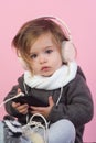 Kid listen music with headset and mp3 on phone. having fun. winter kid fashion. small happy girl. little girl child Royalty Free Stock Photo