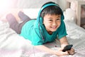 Kid listening to music on bed at bedroom for relax