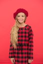 Kid little cute girl with long hair posing in hat red background. Fashionable beret accessory for female. How to wear Royalty Free Stock Photo