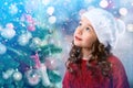 Kid little girl near Christmas tree. New Year card Royalty Free Stock Photo