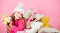 Kid little girl play with soft toy teddy bear pink background. Teddy bears improve psychological wellbeing. Softness is