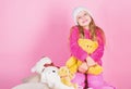 Kid little girl play with soft toy teddy bear pink background. Unique attachments to stuffed animals. Child small girl Royalty Free Stock Photo