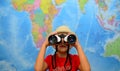 Kid is looking through binoculars around. Adventure and travel concept. Joyful background. Royalty Free Stock Photo