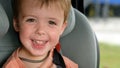 Child smiling while sitting in car seat Royalty Free Stock Photo