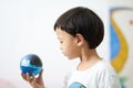 Kid is looking at the earth ball for care the environment concept