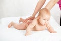 The kid loves a back massage. masseuse doing massage to the baby. Royalty Free Stock Photo