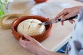 Kid is making dough and cutting cross on easy to prepare and healthy, home made irish soda bread - during stay at home Royalty Free Stock Photo