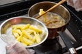 Kid making french fries in kitchen