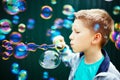 Kid making soap bubbles Royalty Free Stock Photo
