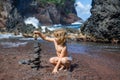 Kid making stack stones on the coast of the sea in the nature. Cairn on the ocean beach, five pebbles tower. Concept of Royalty Free Stock Photo