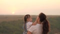 Kid and mama are having fun in the park. Mom plays with a little girl in her hands. Mother and beloved child have fun Royalty Free Stock Photo