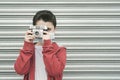 Kid with medical mask take photos with its camera Royalty Free Stock Photo