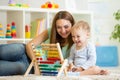 Kid and mother playing with abacus Royalty Free Stock Photo