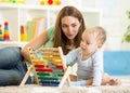 Kid and mother playing with abacus Royalty Free Stock Photo